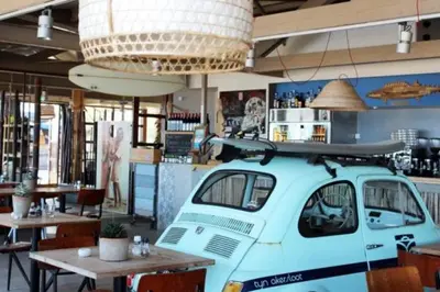 a surfboard on top of a van in a restaurant at In The Heart of Zandvoort in Zandvoort