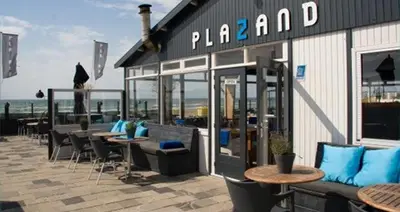 a group of tables and chairs outside of a restaurant at In The Heart of Zandvoort in Zandvoort