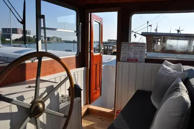 a boat with its door open on the water at Private Lodge on Houseboat Amsterdam in Amsterdam