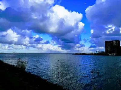 a large body of water under a cloudy sky at Private Lodge on Houseboat Amsterdam in Amsterdam