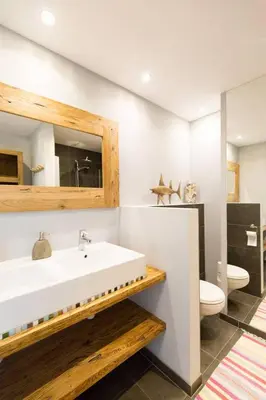 a bathroom with a white sink and a toilet at Zee-en-Zo Noordwijk in Noordwijk