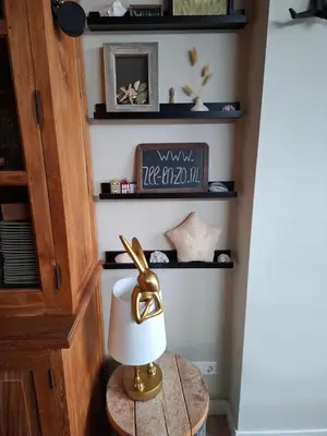 a lamp on a table in a room with shelves at Zee-en-Zo Noordwijk in Noordwijk