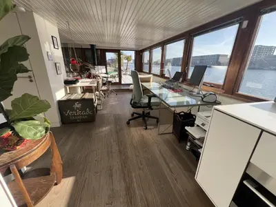 an office with a desk with two computers on it at Stunning boat with a view in Amsterdam