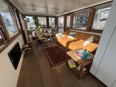 a living room with a couch and a table at Stunning boat with a view in Amsterdam