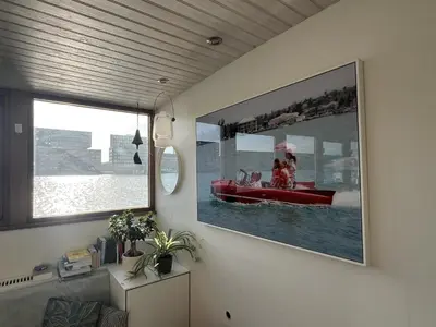 a room with a picture of a boat in the water at Stunning boat with a view in Amsterdam