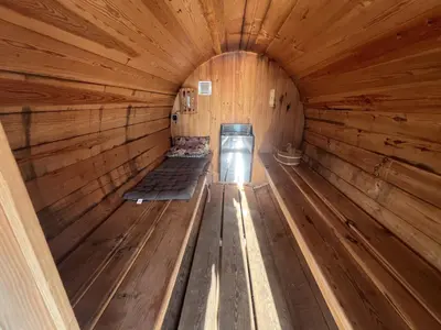 an inside view of a wooden cabin with two beds at Stunning boat with a view in Amsterdam