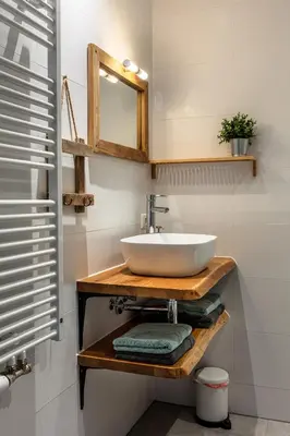 a bathroom with a white sink and a mirror at Boutique Hotel Herberg Binnen in Egmond-Binnen