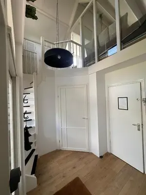 a room with a white door and a staircase at City & Nature-Amsterdam NextDoor Free parking 8 person 2 kitchens in Landsmeer