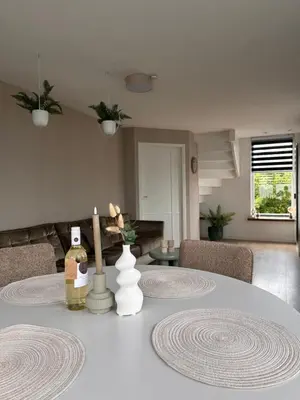 a table with a bottle of wine on top of it at City & Nature-Amsterdam NextDoor Free parking 8 person 2 kitchens in Landsmeer