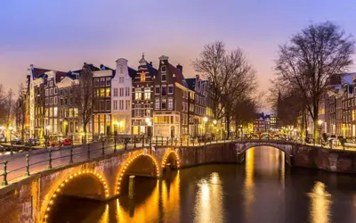 a bridge over a river in a city with buildings at City & Nature-Amsterdam NextDoor Free parking 8 person 2 kitchens in Landsmeer