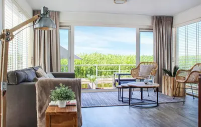 a living room with a couch and a large window at Lovely Ship In Aalsmeer With Kitchen in Aalsmeer