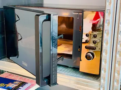 an open door of a toaster oven on a shelf at Private studio, patio garden and free car parking in Amsterdam