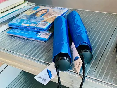 a couple of blue umbrellas on a table at Private studio, patio garden and free car parking in Amsterdam