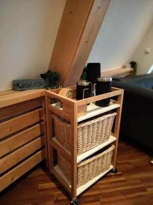 a wooden cabinet with two baskets and a shelf at 4T4 Apartment C in Egmond aan den Hoef