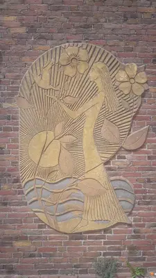 a painting of a woman on a brick wall at 4T4 Apartment C in Egmond aan den Hoef