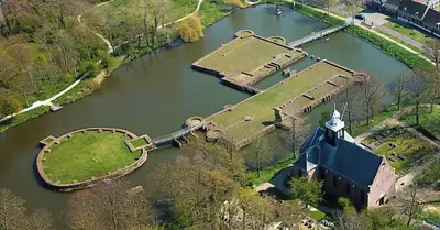 an aerial view of a church in a river at 4T4 Apartment C in Egmond aan den Hoef