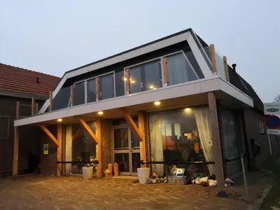 a house with a lot of windows on it at 4T4 Apartment C in Egmond aan den Hoef