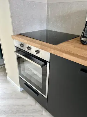 a kitchen with a stove and a counter top at Amsterdam Beach Apartment 34, Private Garden in Zandvoort