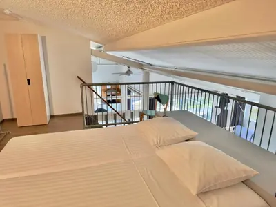 a bedroom with a bed on a balcony at Appartementen Casa del Lago in Lisse