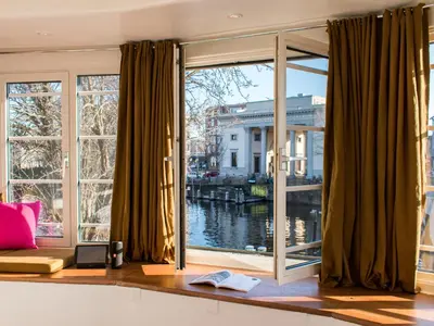 a room with a large window with a view of the water at SWEETS - Willemsbrug in Amsterdam