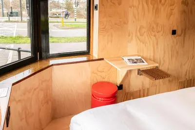 a small room with a bed and a window at SWEETS - Omvalbrug in Amsterdam