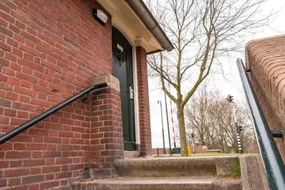 an open door of a brick building with stairs at SWEETS - Omvalbrug in Amsterdam