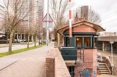 a small brick train station on a city street at SWEETS - Omvalbrug in Amsterdam