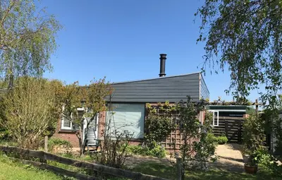 a house with a fence in front of it at Bungalow 221 in Noordwijkerhout