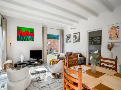 a living room with a table and a couch at Bungalow in Noordwijk near Beaches in Noordwijkerhout