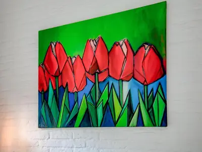 a painting of red tulips hanging on a wall at Bungalow in Noordwijk near Beaches in Noordwijkerhout