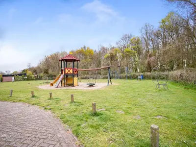 a park with a playground with a play structure at Bungalow in Noordwijk near Beaches in Noordwijkerhout
