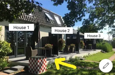 a house with two signs that say house and house at Mooi appartement in een prachtige fiets-wandelomgeving in Abcoude