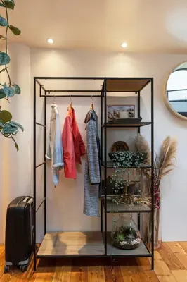 a walk in closet with a shelf and clothes at B&B Houseboat Amsterdam in Amsterdam