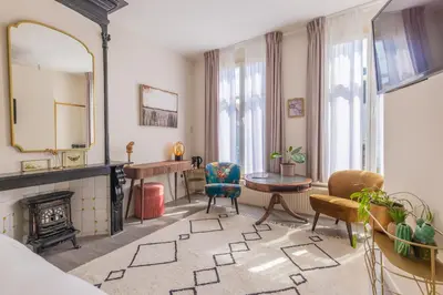 a living room with a fireplace and a mirror at LOT Hotel in Leiden