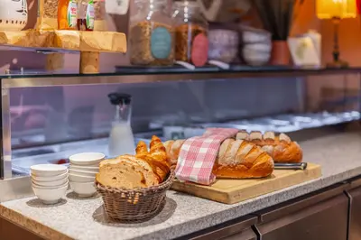 a bakery with bread and pastries on a counter at LOT Hotel in Leiden