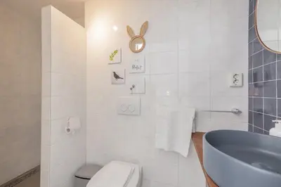 a bathroom with a tub and a toilet and a sink at LOT Hotel in Leiden