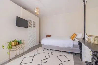 a bedroom with a bed and a flat screen tv at LOT Hotel in Leiden