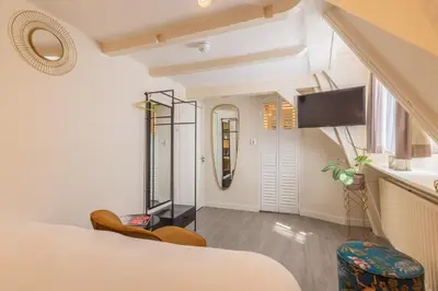 a hotel room with a bed and a mirror at LOT Hotel in Leiden