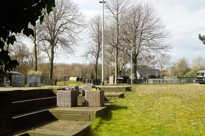 a park with benches and trees and a street light at Have a nice stay! - Souterrain The Freesia in Noordwijk