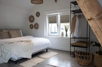 a bedroom with a bed and a window at Hotel Paradis Zandvoort in Zandvoort