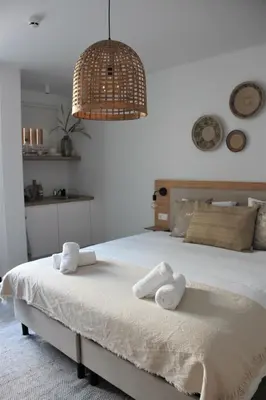 a bedroom with a bed with towels on it at Hotel Paradis Zandvoort in Zandvoort