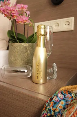 a bottle of champagne sitting on a table with a glass at Zeevonk Studio's & Appartementen in Katwijk aan Zee