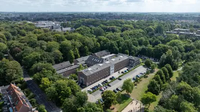 an aerial view of a building in the middle of a forest at Fletcher Hotel-Restaurant De Oude Gevangenis-Alkmaar in Alkmaar