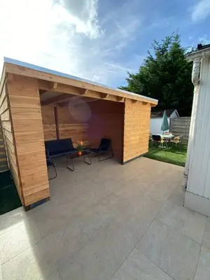 a pavilion with a table and chairs on a patio at Chalet at a holiday park in Opmeer near Amsterdam in Opmeer