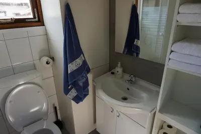 a small bathroom with a toilet and a sink at Chalet at a holiday park in Opmeer near Amsterdam in Opmeer
