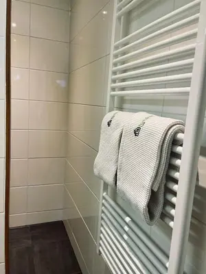a bathroom with a towel hanging on a shower door at Gorgeous And Stylish Place For Two In Hip West! in Amsterdam