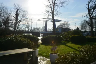 a park with a bench and a tower in the background at 'Room Eleven' aan de Vecht in Vreeland
