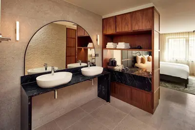 a bathroom with two sinks and a large mirror at Met Hotel Amsterdam in Amsterdam