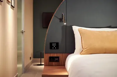 a bedroom with a bed with a clock on it at Met Hotel Amsterdam in Amsterdam