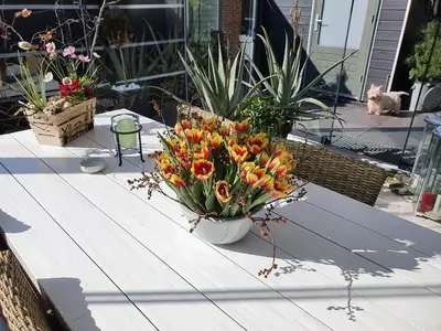 a white table with a bunch of flowers on it at B&B Modern Times in Amsterdam